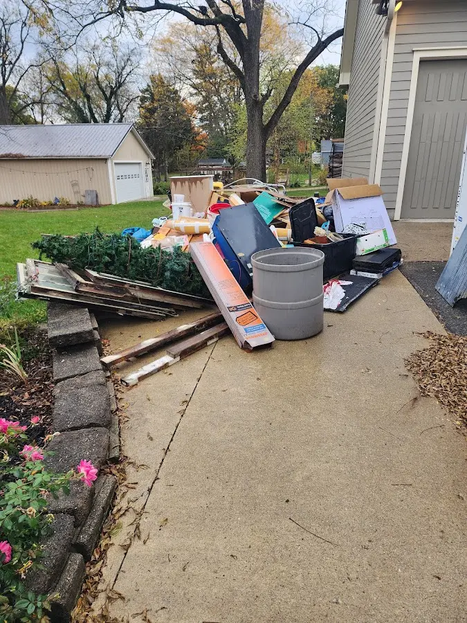 Dumpster being loaded with debris for 12 Yard Dumpster Rental in Garfield